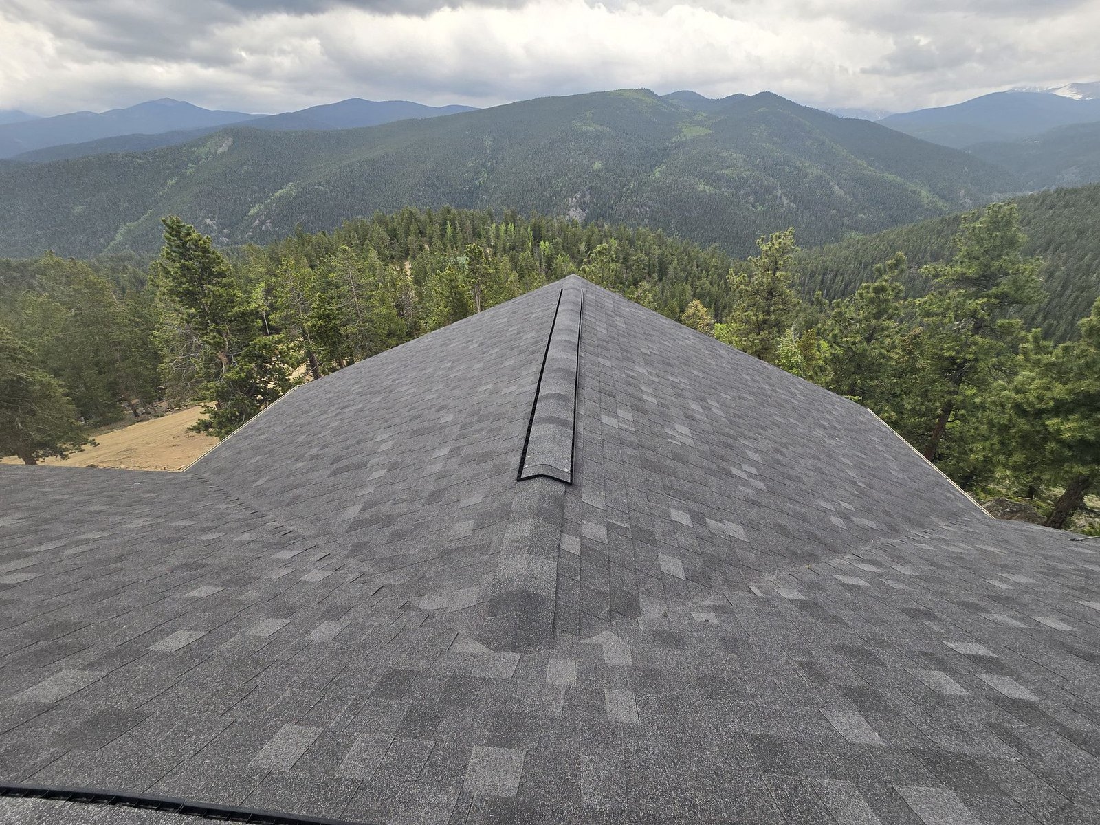 Professional roofing contractors installing asphalt shingles